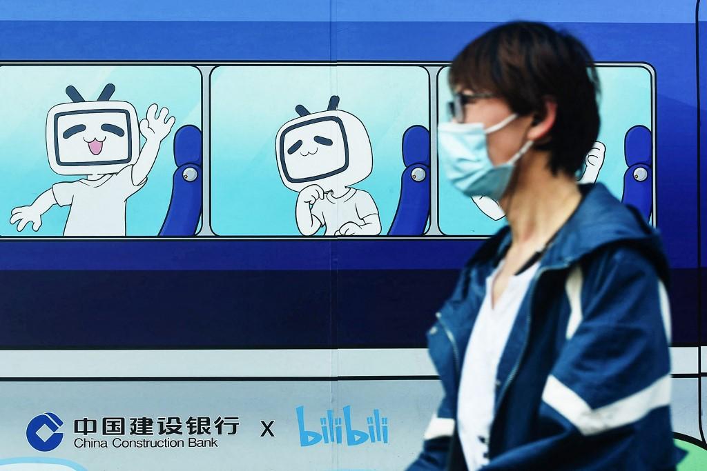 A pedestrian walks past images of the mascot and logo of video streaming site Bilibili in Hangzhou, China's eastern Zhejiang province, on March 29, 2021. Photo: AFP