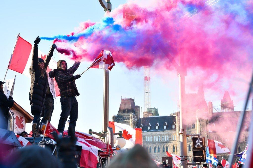 Protesters release smoke flares on Feb 5 in Ottawa, Canada. Photo: AFP