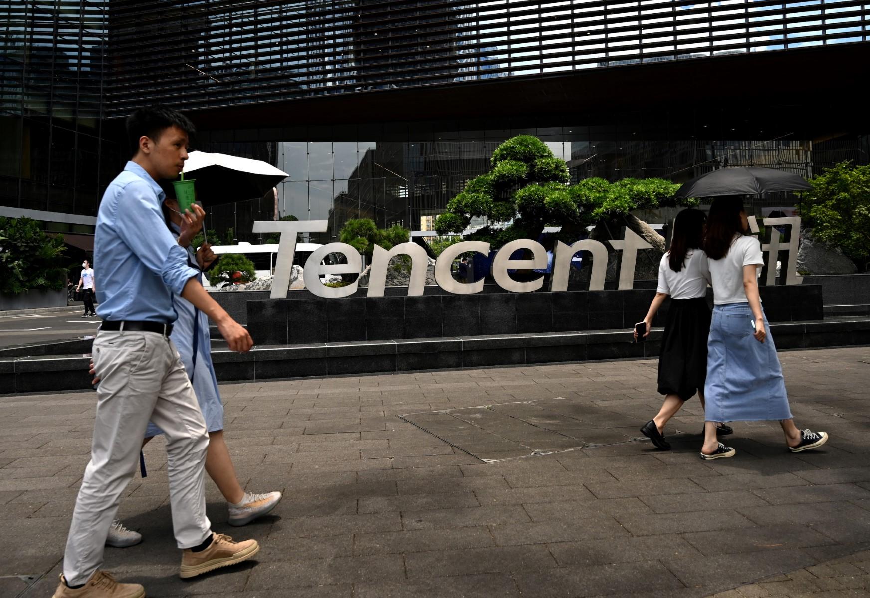This photo taken on May 26, 2021 shows people walking past the Tencent headquarters in the southern Chinese city of Shenzhen, in Guangdong province. Photo: AFP