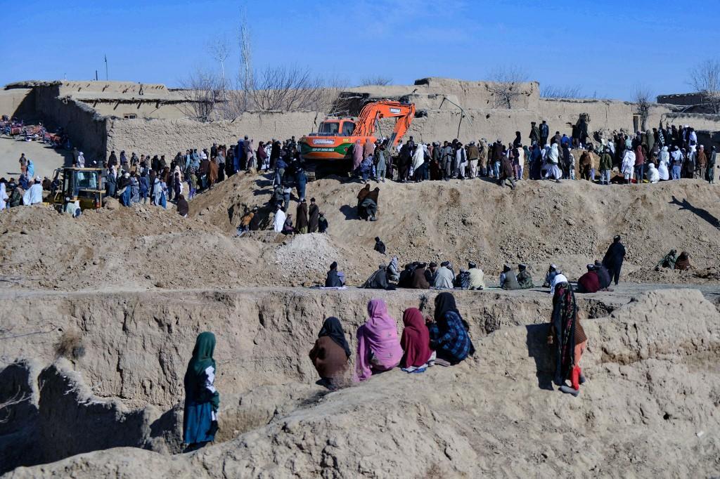 Afghan people gather as rescuers try to reach and rescue a boy trapped for days down a well in a remote southern Afghan village of Shokak, in Zabul province about 120km from Kandahar on Feb 17. Photo: AFP