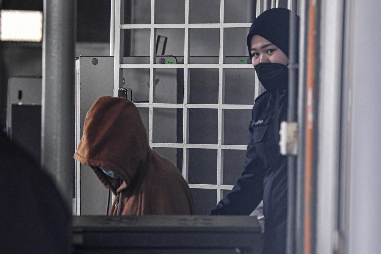 The teenager accused of killing a newborn baby on Feb 8 is escorted to the Kemaman Magistrate's Court in Terengganu on Feb 15. Photo: Bernama