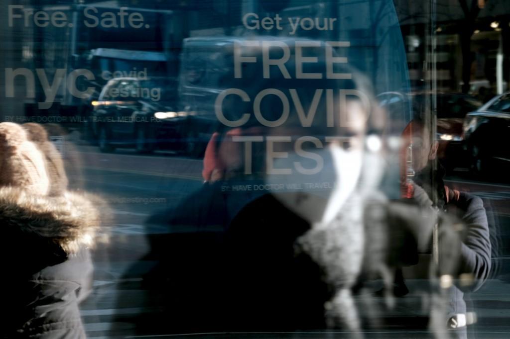 People pass a Covid-19 testing van along a Manhattan street on Jan 21 in New York City. Photo: AFP
