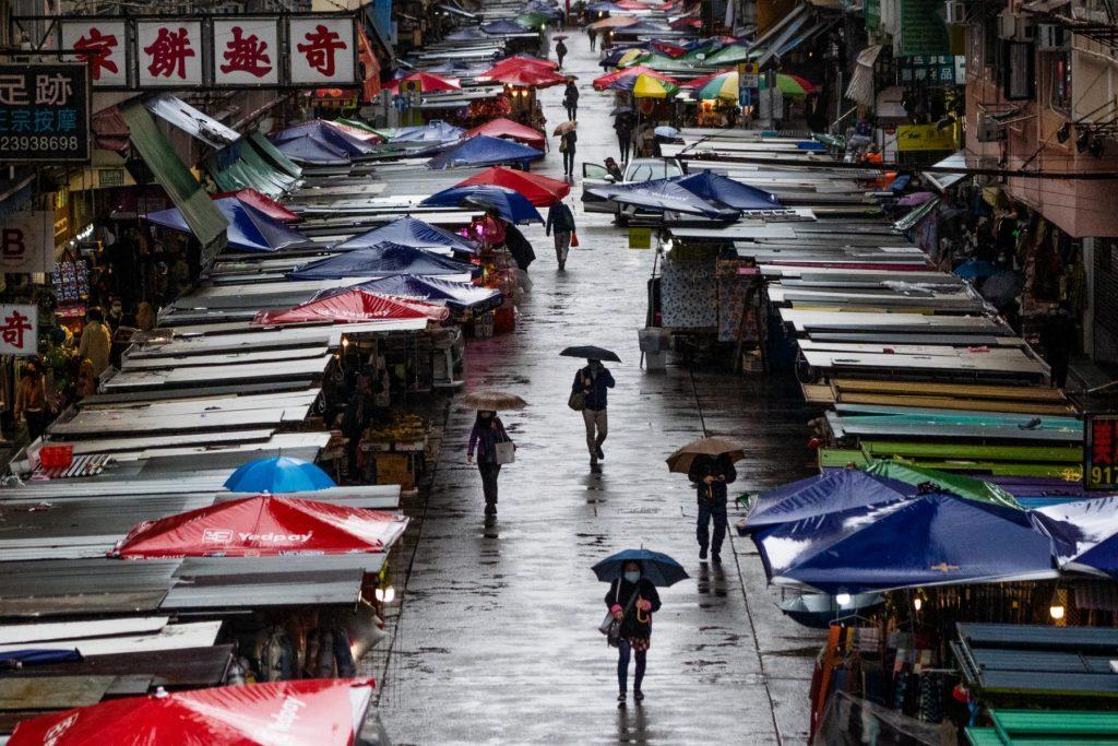 Pedestrians walk in the rain in Hong Kong’s Mongkok area on Feb 20. Photo: AFP