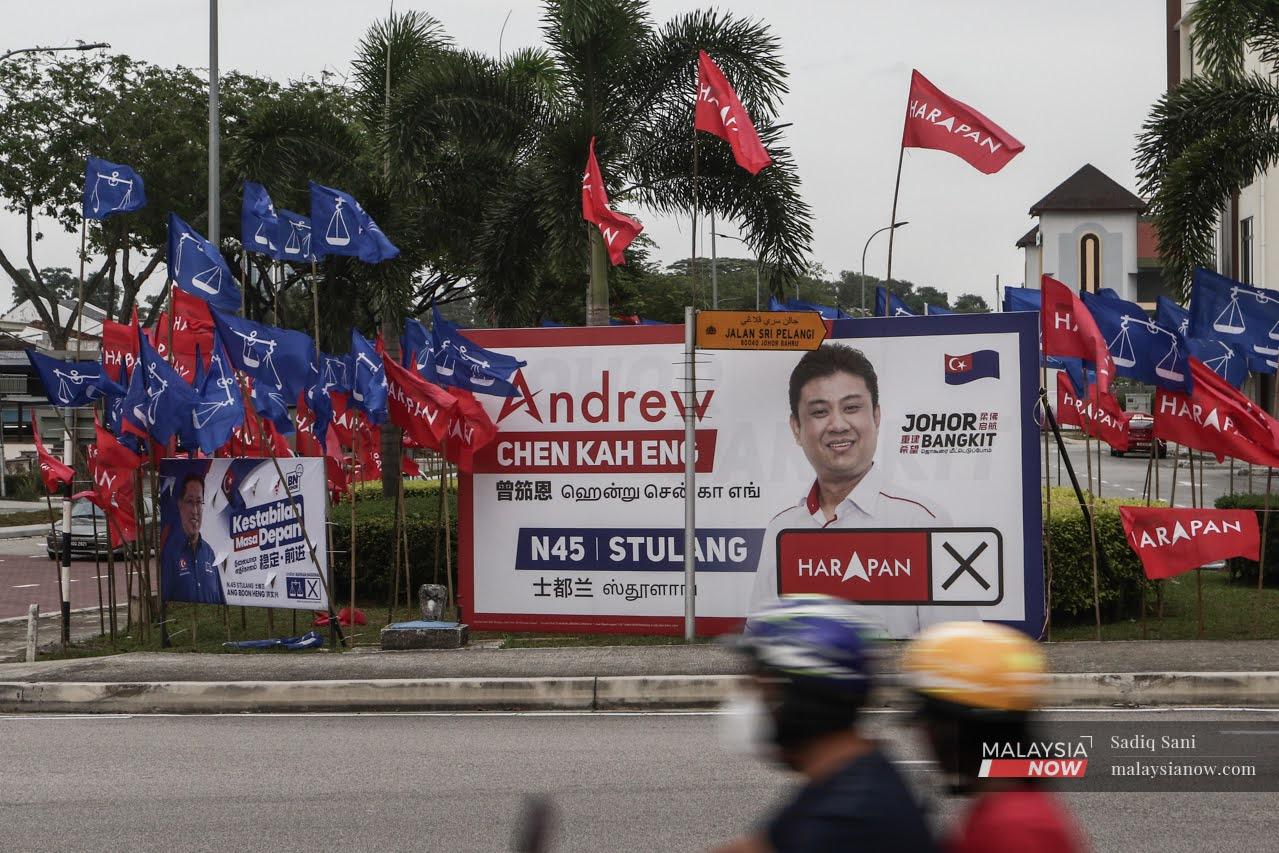 Party flags and billboards of candidates line the junction at a road in Stulang, Johor Bahru, ahead of the state election on March 12.