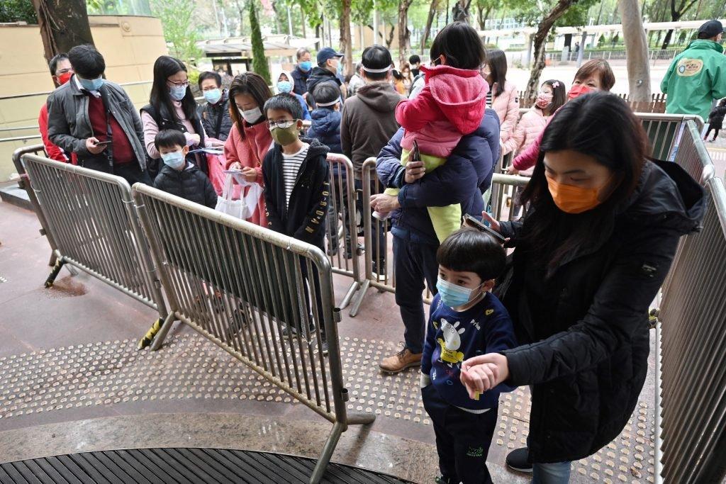 People queue up for Covid-19 tests outside a community vaccination centre especially for children and the elderly in Hong Kong on Feb 23, as the city faces its worst coronavirus wave to date. Photo: AFP