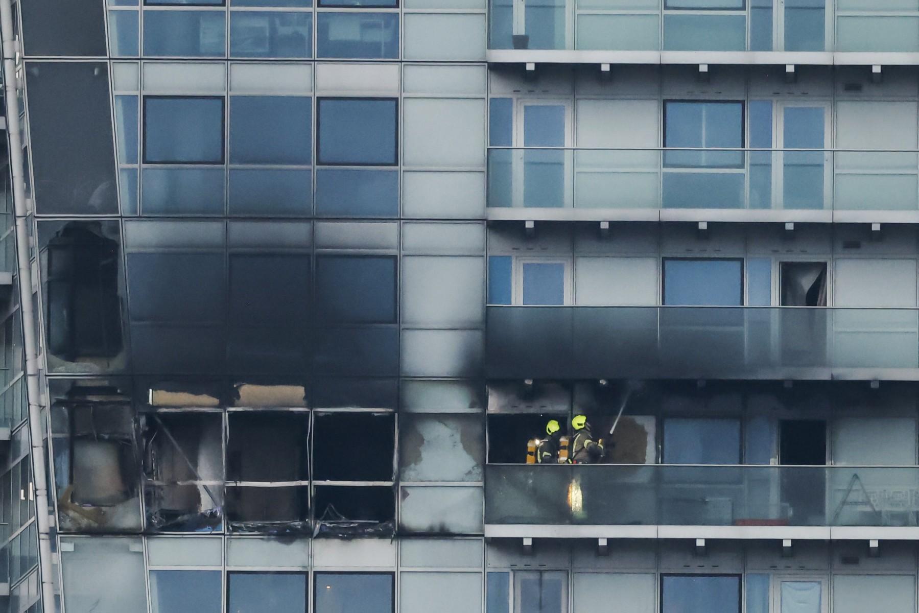 Firefighters extinguish the rest of a fire that broke out in the Relay Building, in Aldgate, east London, on March 7. Photo: AFP