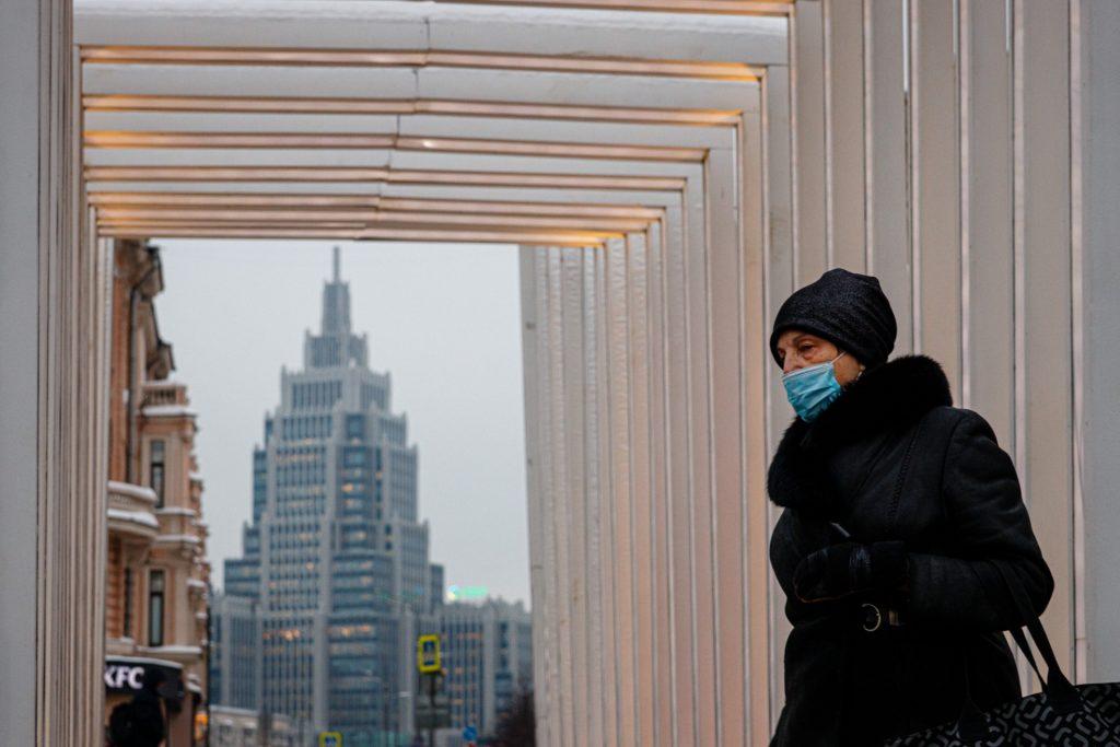 A woman wearing a face mask walks in Moscow on Jan 24. The possibility that the US might ban Russian oil imports would be unprecedented, turbocharging already sky-high prices and risking inflationary shock. Photo: AFP