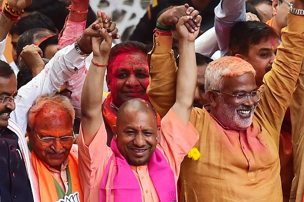 Chief Minister of India's Uttar Pradesh state Yogi Adityanath (wearing pink scarf) gestures to his supporters after Bharatiya Janata Party's win in the state assembly elections at the party office in Lucknow on March 10. Photo: AFP