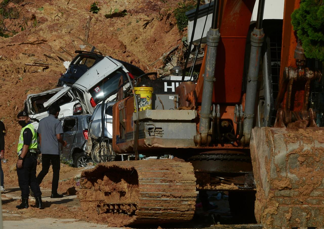 Anggota polis memantau keselamatan kawasan perumahan yang terjejas ekoran kejadian tanah runtuh di Taman Bukit Permai 2, Ampang hari ini. Gambar: Bernama