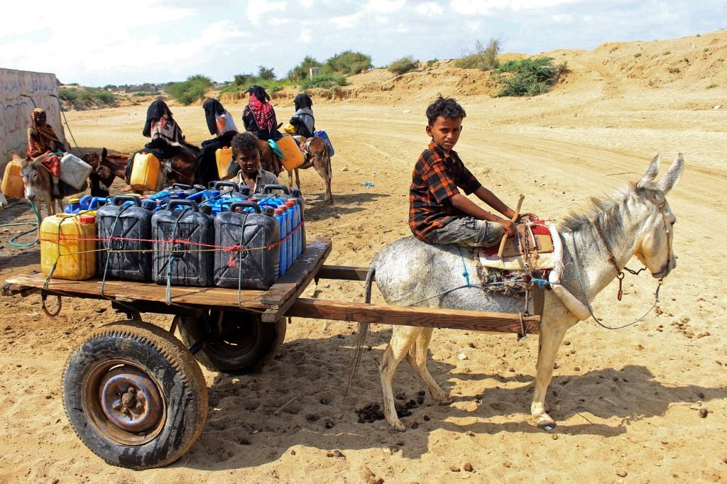 Yemeni children ride donkeys to fill their jerrycans with water at a make-shift camp for the internally displaced, in the northern Hajjah province, on Jan 16, amid a severe shortage of water. Photo: AFP