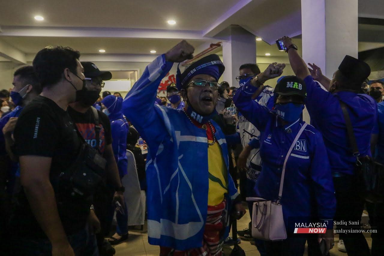 Barisan Nasional supporters at the coalition's operations room in Johor call for Parliament to be dissolved so that the next general election can be held.