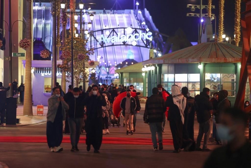 People walk beneath advertisement billboards at Boulevard entertainment city in the Saudi capital Riyadh, late on Jan 19. The wealthy Gulf country has one of the world's highest execution rates, and has often carried out previous death sentences by beheading. Photo: AFP
