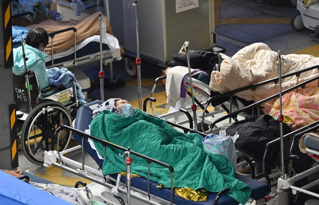 People lie in hospital beds outside the Caritas Medical Centre in Hong Kong on Feb 18, as the city faces its worst Covid-19 wave to date. Photo: AFP