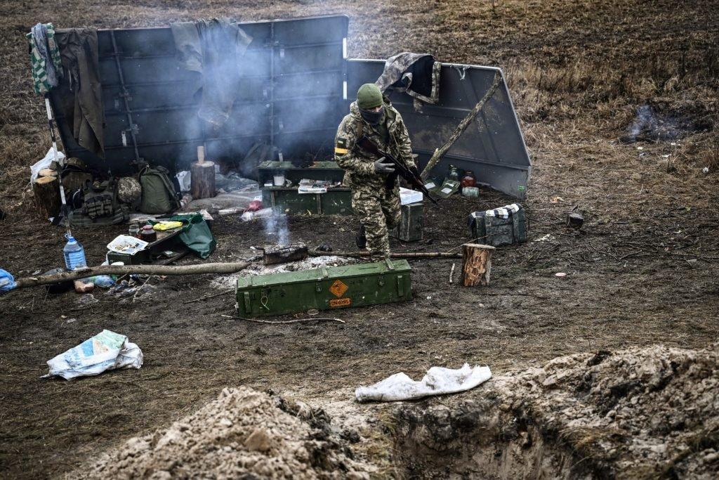 A Ukrainian soldier walks next to a camp fire at a frontline, northeast of Kyiv on March 3. Photo: AFP