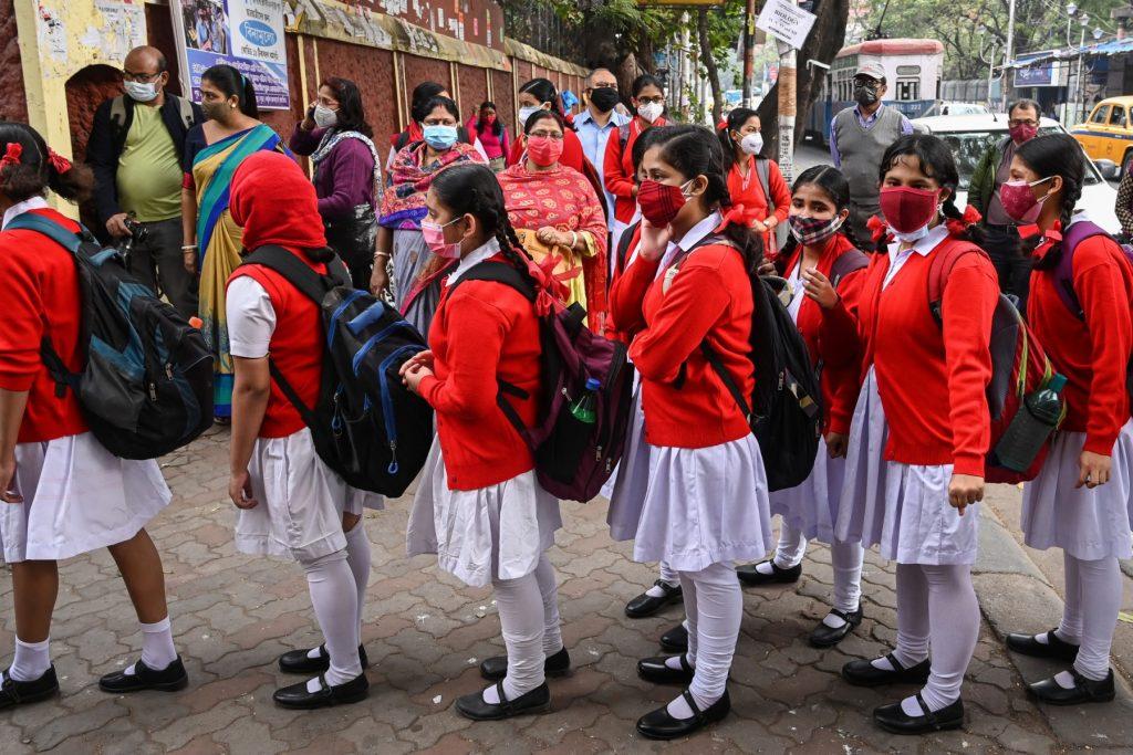 Children queue up to enter the school premises after schools resumed physical classes in Kolkata on Feb 3. Photo: AFP