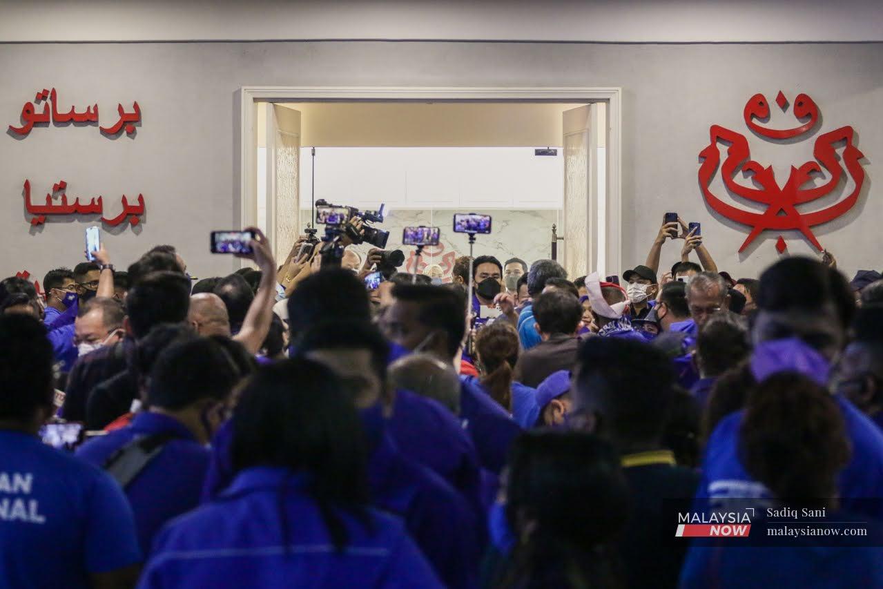 Barisan Nasional supporters gather at the Umno headquarters in Johor while awaiting the outcome of the state election on March 12.