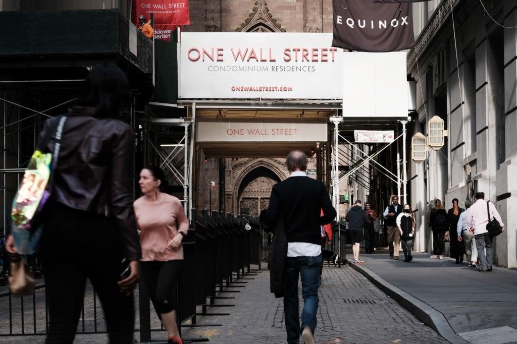 People walk outside of the New York Stock Exchange on Oct 25, 2021 in