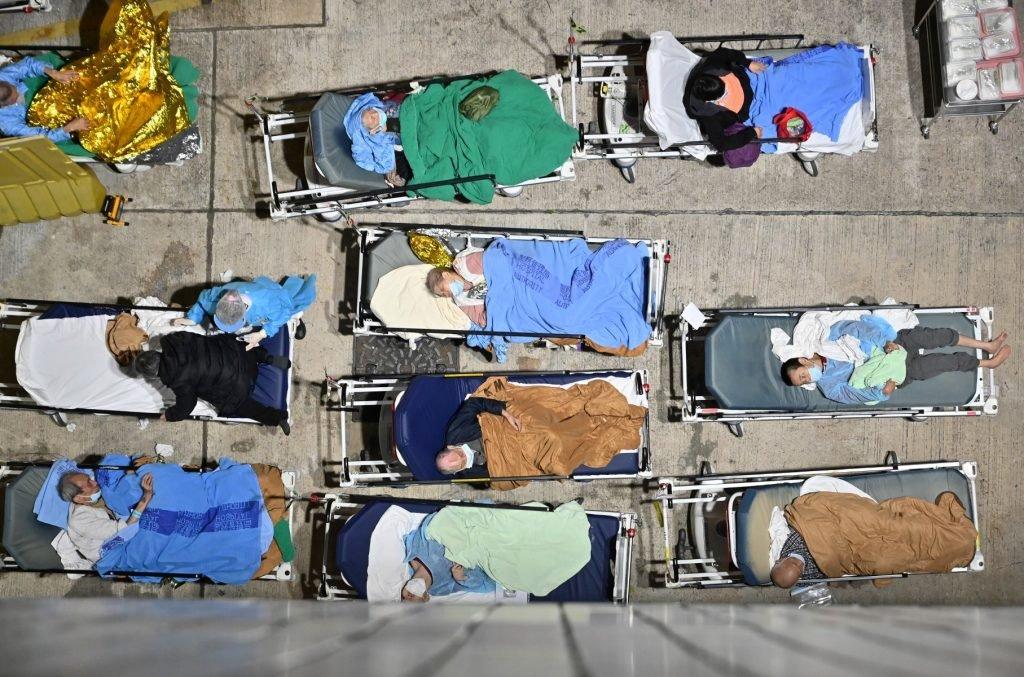 People sleep in hospital beds with temperatures falling at night-time outside the Caritas Medical Centre in Hong Kong on Feb 16, as hospitals become overwhelmed with the city facing its worst Covid-19 wave to date. Photo: AFP