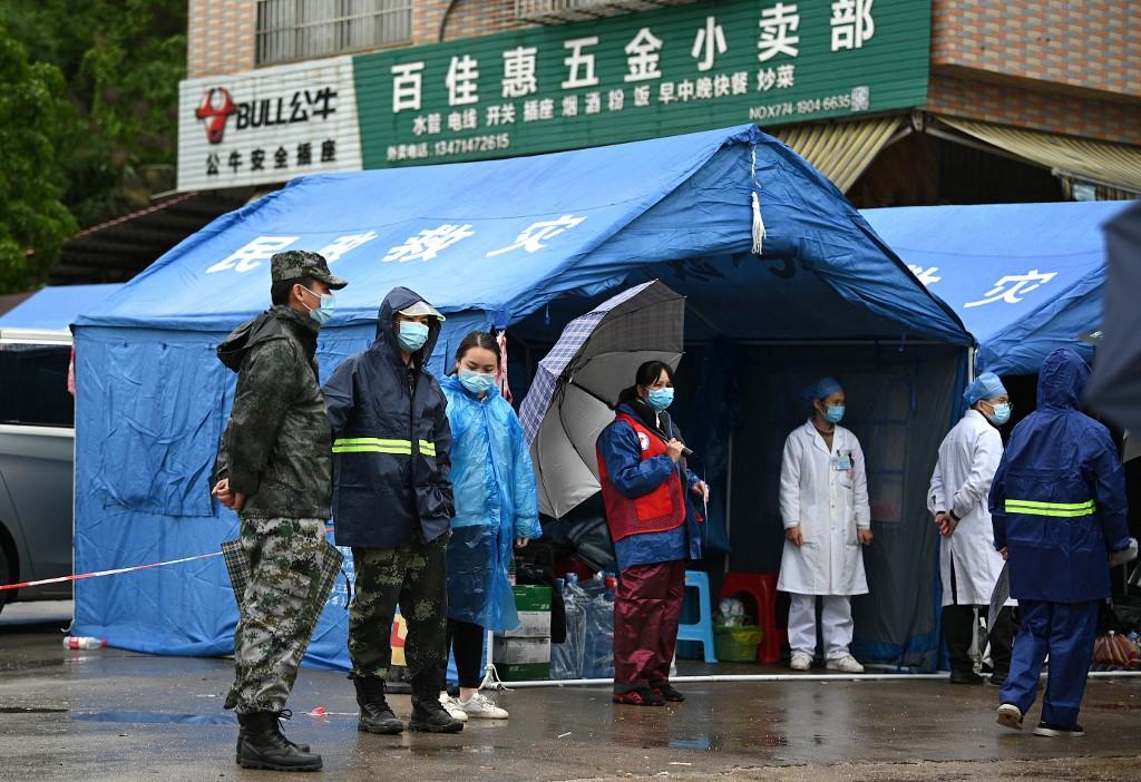 Security personnel guard the entrance of the village which leads to the crash site of China Eastern flight MU5375 in Wuzhou, in southwestern China's Guangxi province on March 23. Photo: AFP