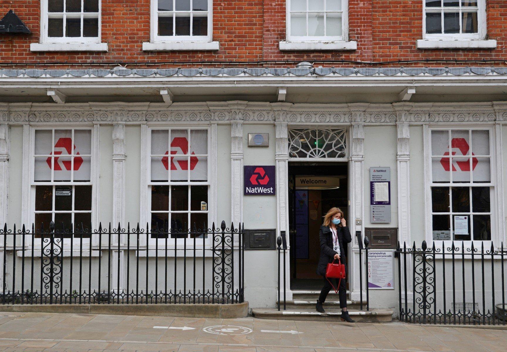 Customers use a NatWest bank on the High Street in Winchester, south west England on March 31, 2021. Photo: AFP