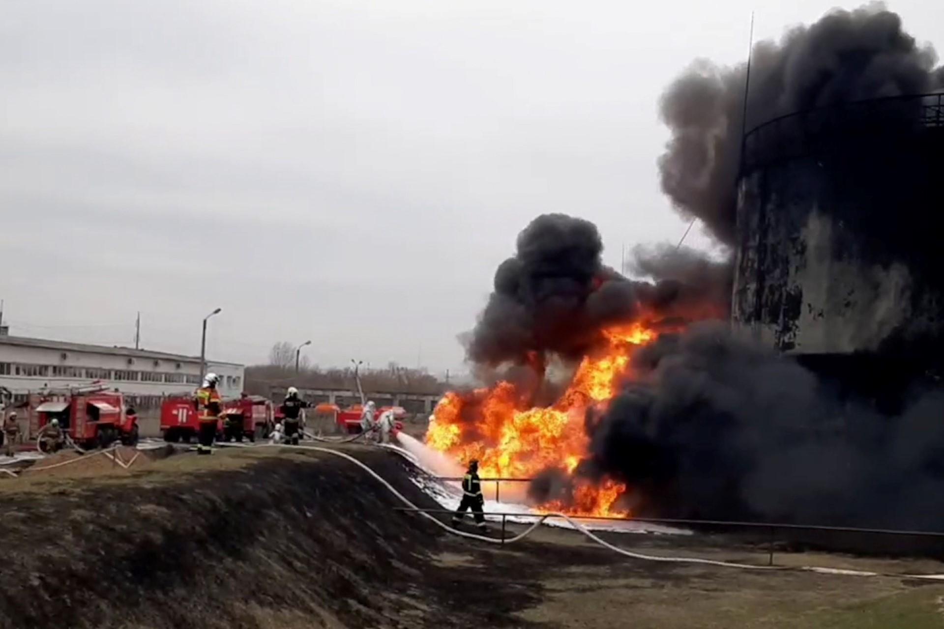 This video grab taken from a handout footage released by the Russian Emergencies Ministry on April 1 shows firemen working to extinguish a fire at a Rosneft fuel depot in the town of Belgorod, some 40km from Russia's border with Ukraine. Photo: AFP