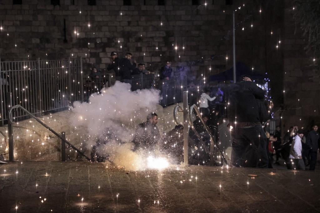 A riot flare explodes outside the Damascus of the old city of Jerusalem during clashes between Palestinians and Israeli security forces late on April 3. Photo: AFP