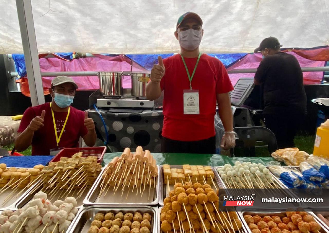 A trader gives the thumbs up sign at the Stutong Ramadan bazaar in Kuching.