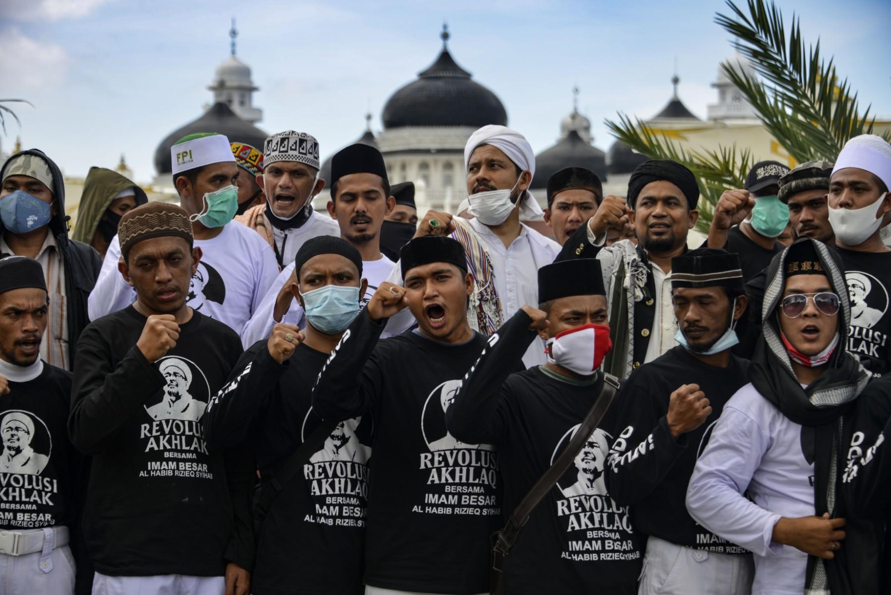 Supporters of Rizieq Shihab, leader of Indonesian hardline organisation Islamic Defenders Front, gather in a show of support for the firebrand cleric in front of the Baiturrahman grand mosque in Banda Aceh on Dec 8, 2020. Rizieq was jailed for spreading false information about Covid-19. Photo: AFP