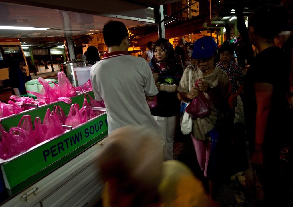 Volunteers from the Pertiwi soup kitchen distribute food to homeless people in Kuala Lumpur in this file photo. Photo: AFP