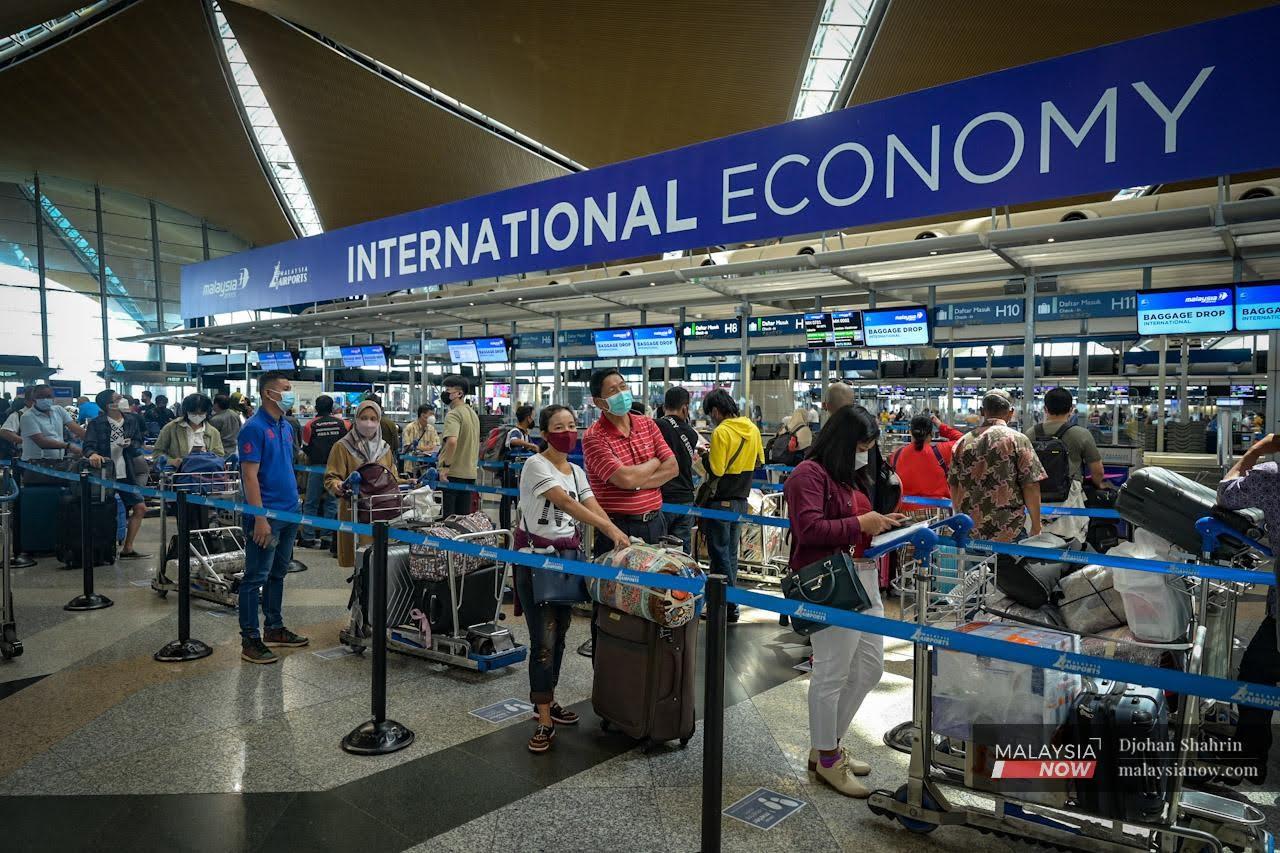 Travellers queue at a check-in counter at KLIA after Malaysia's borders reopened on April 1.