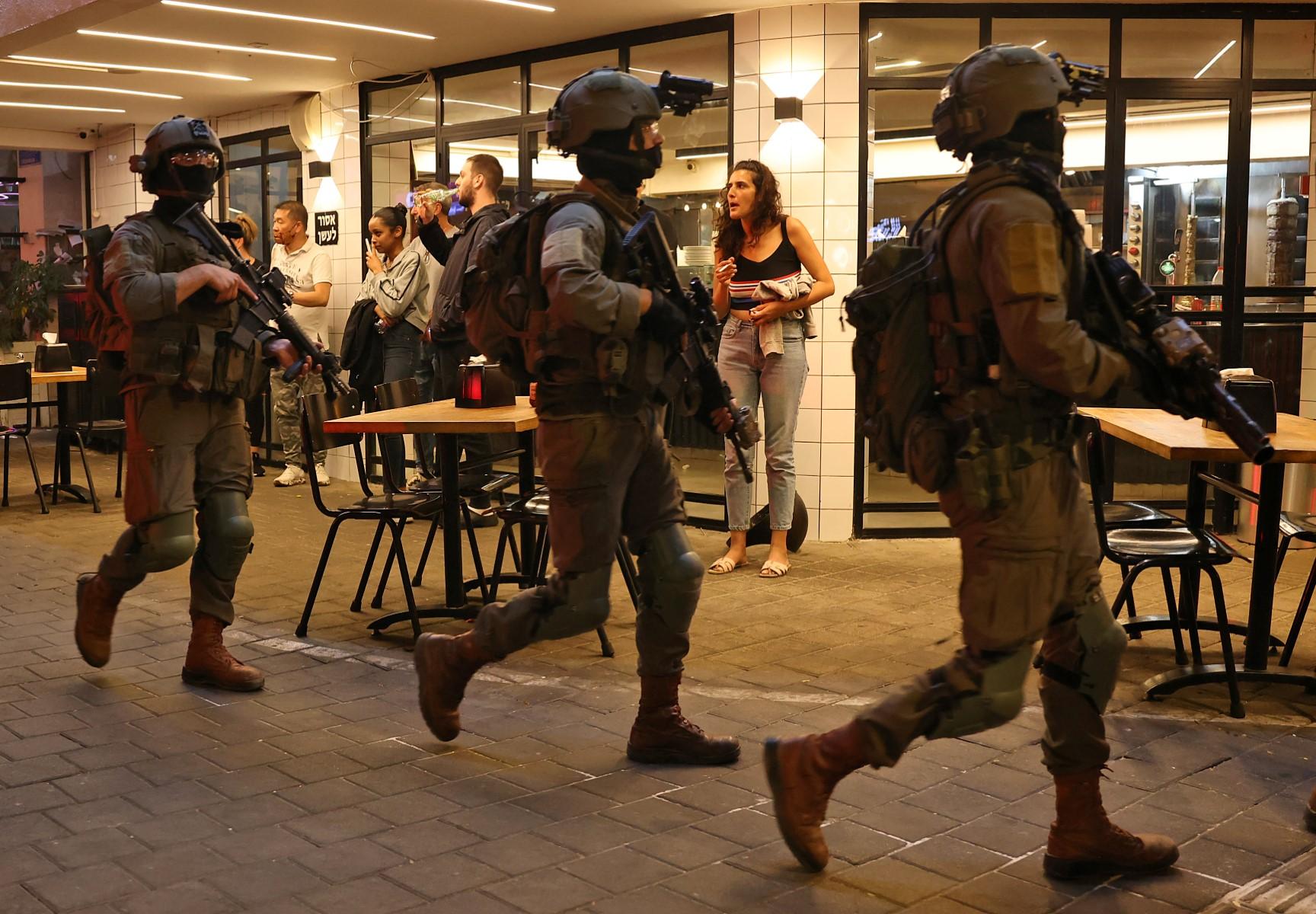 Security forces gather outside a restaurant at the scene of a shooting attack in Dizengoff Street in the centre of Israel's Mediterranean coastal city of Tel Aviv on April 7. Photo: AFP