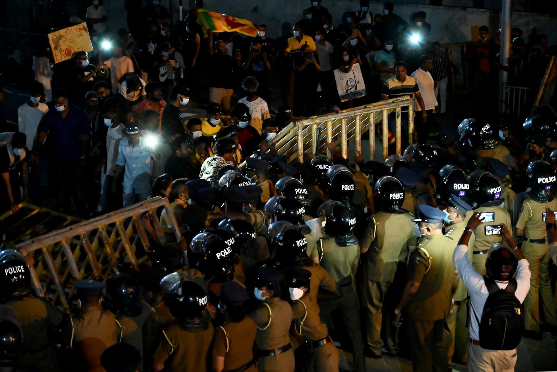 Anti-riot police officers attempt to block protesters during a rally against the rise of prices and shortage of fuel at the entrance road of the Sri Lanka prime minister's official residence in Colombo on April 7. Photo: AFP