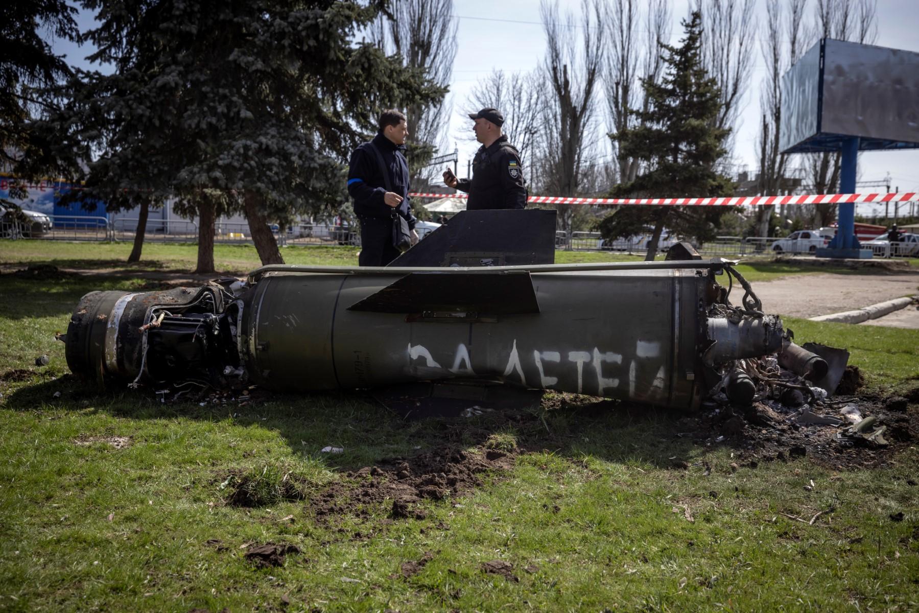 Ukrainian police inspect the remains of a large rocket with the words 'for our children' in Russian next to the main building of a train station in Kramatorsk, eastern Ukraine, used for civilian evacuations that was hit by a rocket attack killing at least 35 people, on April 8. Photo: AFP