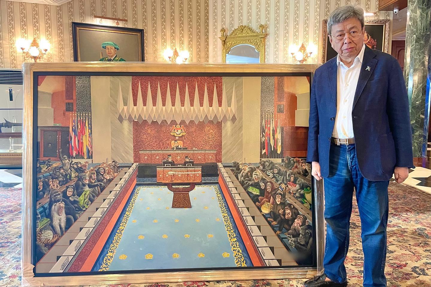 Selangor ruler Sultan Sharafuddin Idris Shah stands beside a painting depicting MPs as monkeys and frogs which the palace says he has bought to hang in his private study. Photo: Selangor palace Facebook