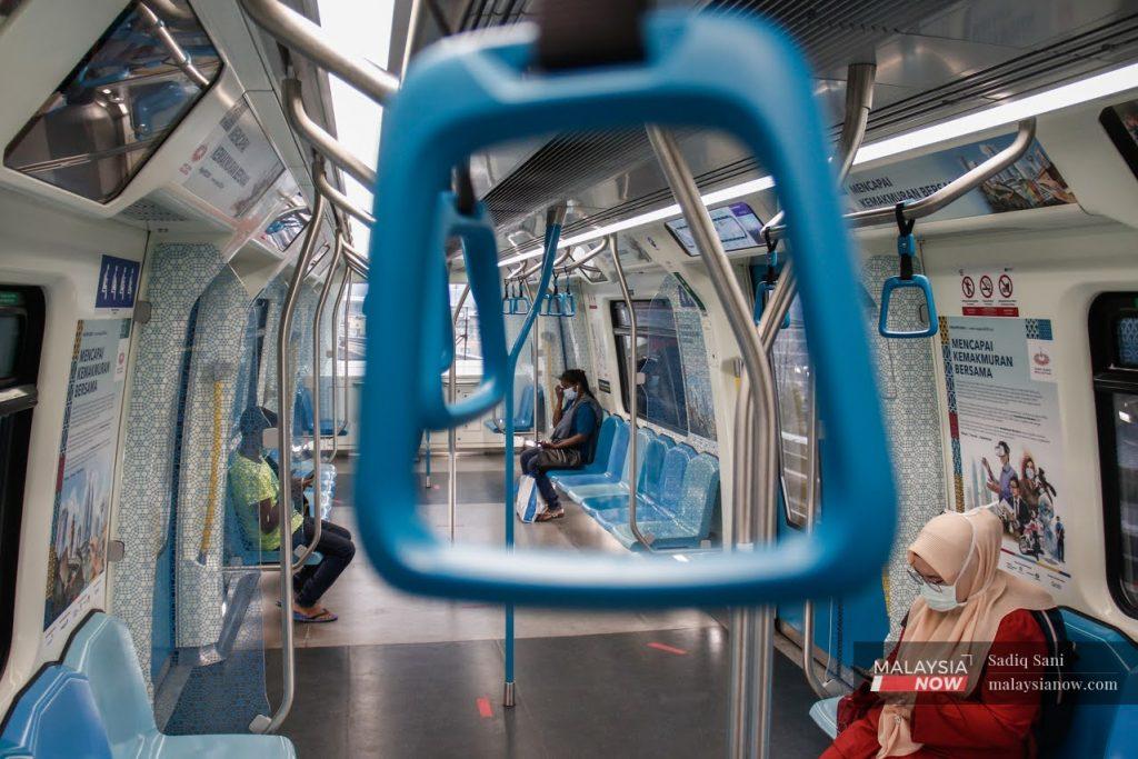Passengers wearing face masks observe physical distancing in an MRT heading to Bukit Bintang in Kuala Lumpur.