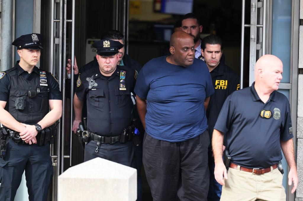 Suspect Frank James is led by police from Ninth Precinct after being arrested for his connection to the mass shooting at the 36th St subway station on April 13, in New York City. Photo: AFP