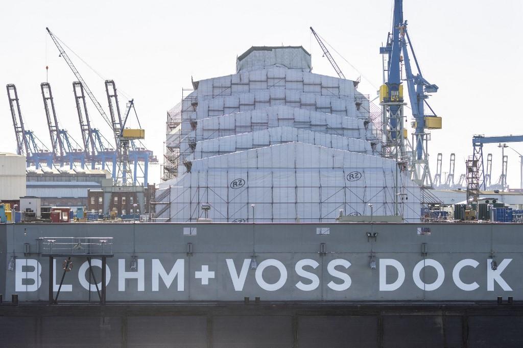 A giant scaffolding covered in tarpaulin covers the superyacht 'Dilbar' lying in dry dock at the German shipbuilding company Blohm + Voss compound on the river Elbe at the harbour in Hamburg, northern Germany, on March 7. Photo: AFP
