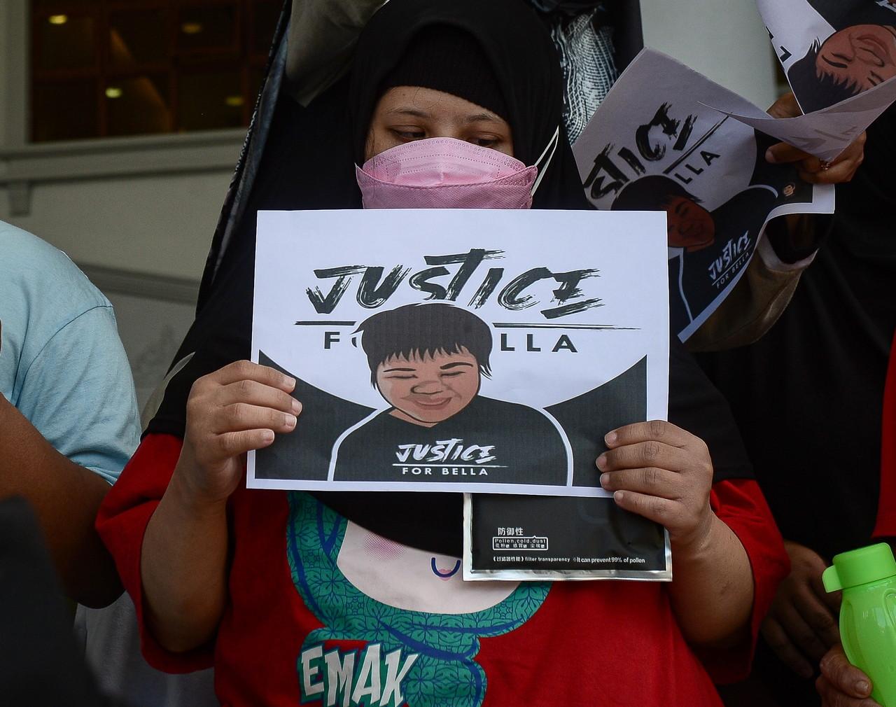 A girl from the Down Syndrome Association of Malaysia holds up a placard reading 'Justice for Bella' outside the Kuala Lumpur court complex during the trial of Rumah Bonda founder Siti Bainun Ahd Razali on April 1. Photo: Bernama