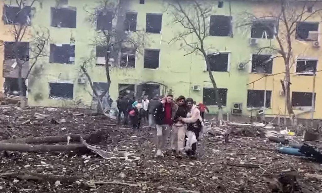 In this video grab from a handout footage taken and released by the the National Police of Ukraine on March 9, people are helped out of a damaged building of a children's hospital following a Russian air strike in the southeastern city of Mariupol. Photo: AFP