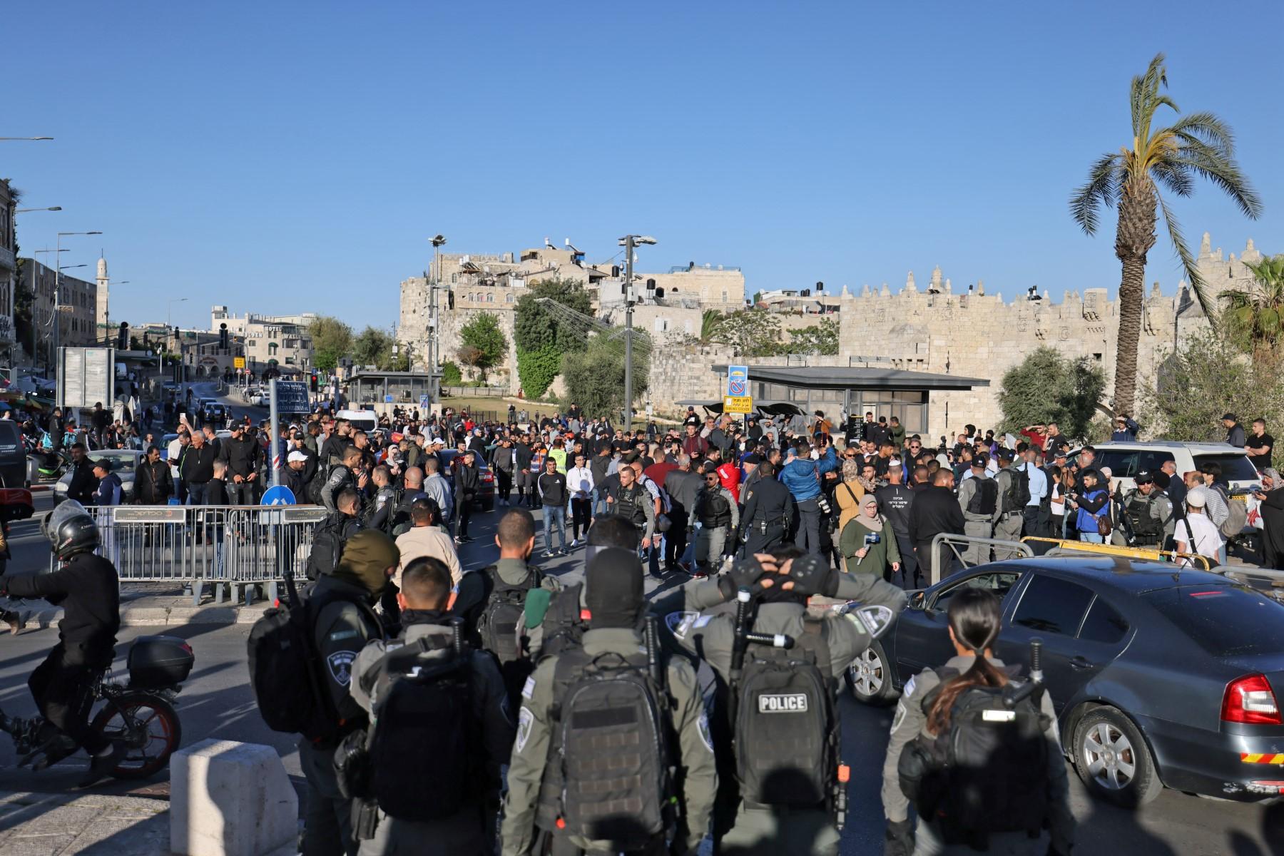 Israeli security forces keep Palestinians at bay in front of the Damascus Gate in Jerusalem's Old City, as they gather to watch Israeli protesters marching with national flags toward Tzahal square on April 20. Photo: AFP