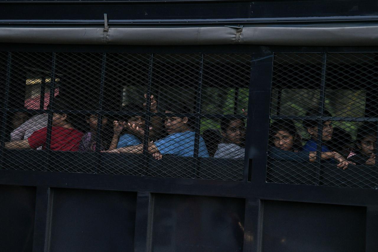 Lorries from the immigration department carrying Rohingya detainees leave the temporary detention depot in Relau Bandar Baharu. Photo: Bernama