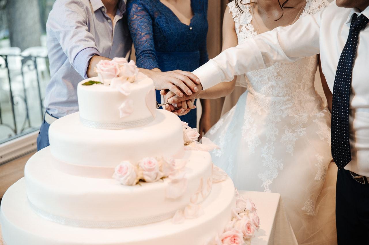 A bridal party cuts the wedding cake in this file picture. A bride and her caterer have been arrested after a prank in which they were said to have put marijuana in the food. Photo: Pexels