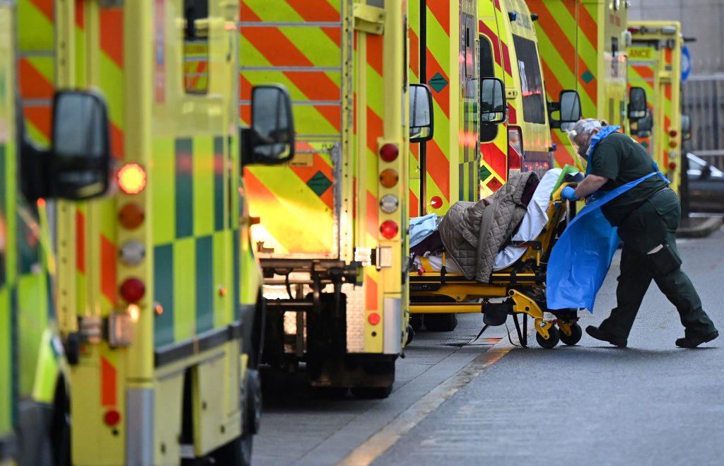 A paramedic is seen by a line of ambulances outside the Royal London Hospital in east London on Jan 5. Photo: AFP