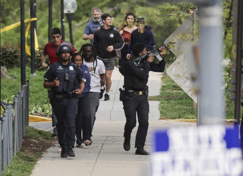 Police escort people away from a shooting scene in the northwest part of Washington, DC on April 22. Photo: AFP