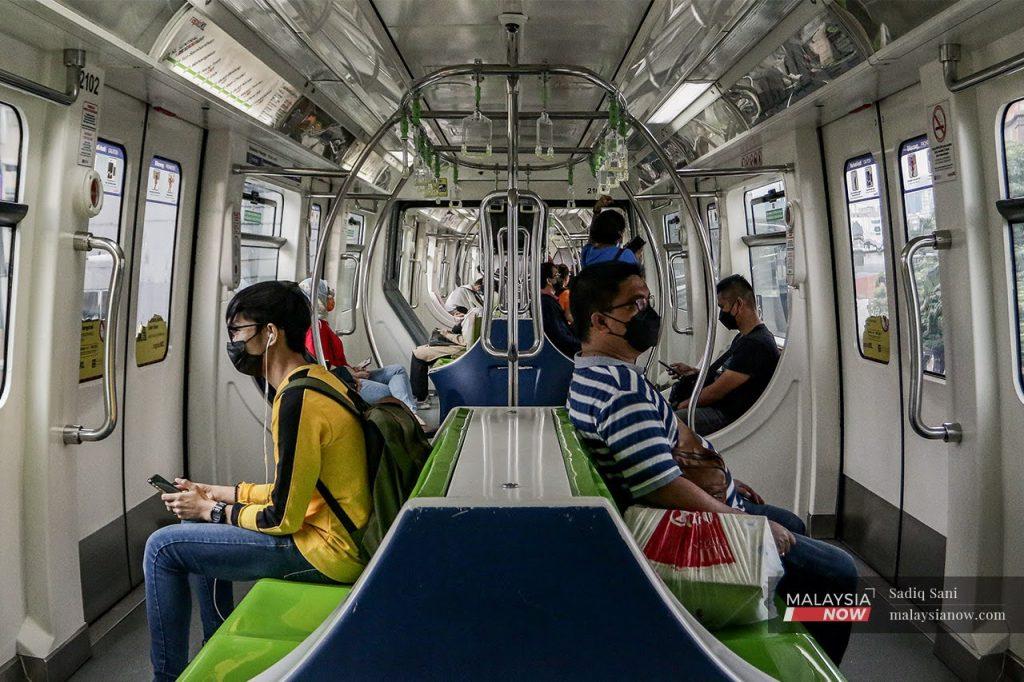 Passengers wearing face masks to curb the spread of Covid-19 take a monorail train to Bukit Bintang in Kuala Lumpur.
