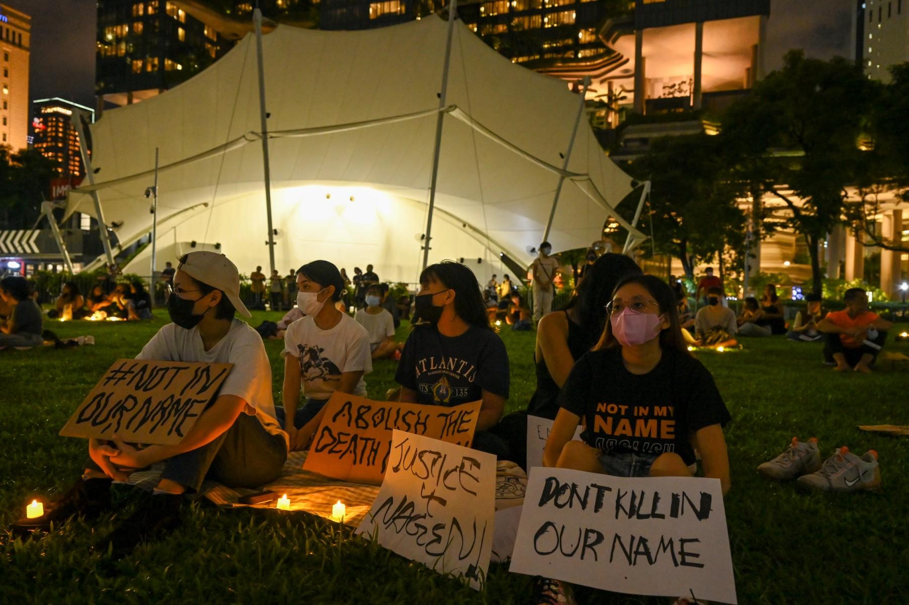 People display placards and LED lights during a vigil for Nagaenthran K Dharmalingam, sentenced to death for trafficking heroin into Singapore, at Speakers Corner in Singapore on April 25. Photo: AFP