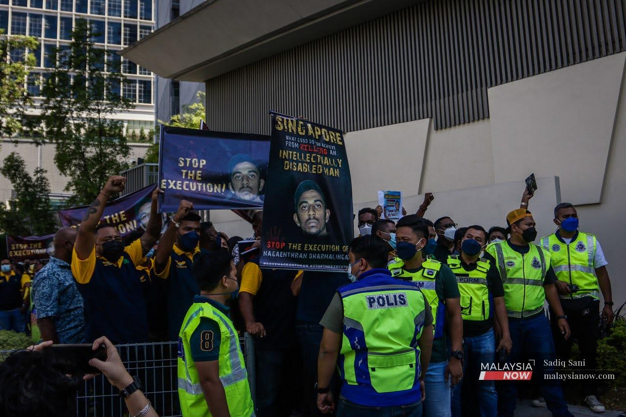 Police keep watch as protesters gather in front of the Singapore High Commission in Kuala Lumpur to protest the impending execution of Nagaenthran K Dharmalingam.