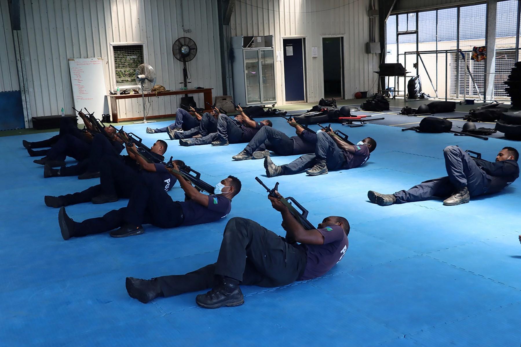 An undated handout photo released on March 29 by the Royal Solomon Islands Police Force (RSIPF) shows China Police Liason Team officers training local RSIPF officers in drill, unarmed combat skills, advanced usage of long sticks, round shields, tactical batons, T-shape baton, handcuffs, basic rifle tactics and crowd control. Photo: AFP