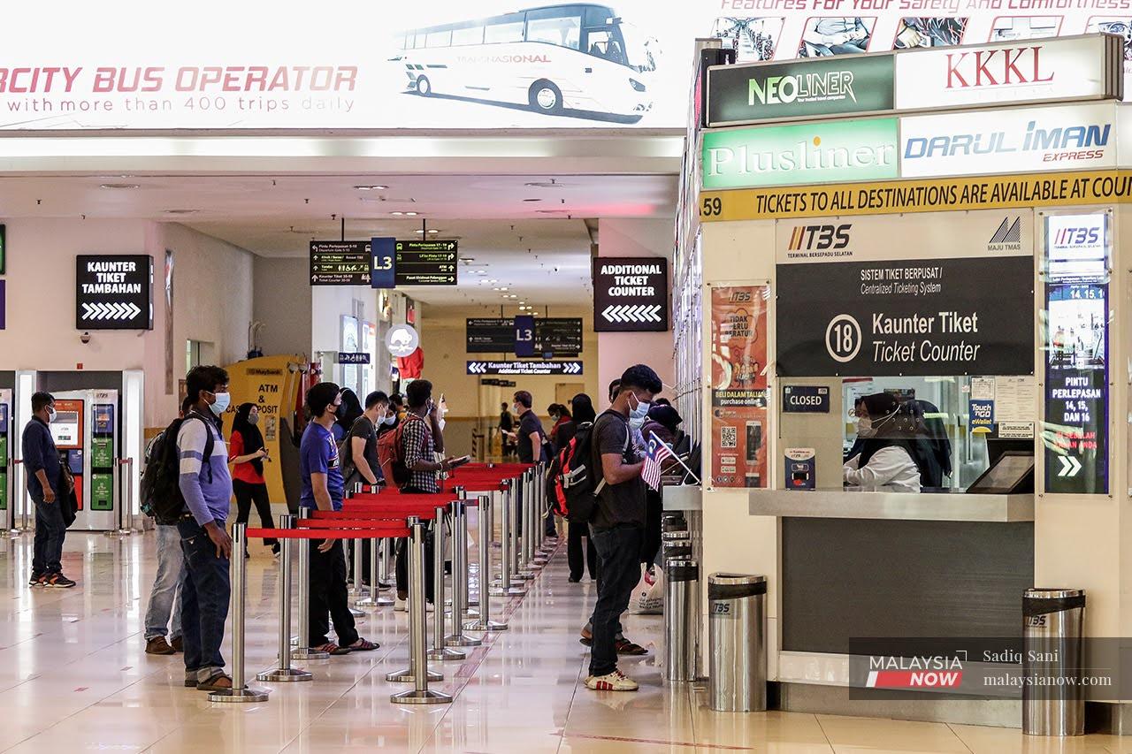 Passengers queue for tickets at the counter of the South Integrated Terminal in Cheras, as restrictions on interstate travel were lifted last October.