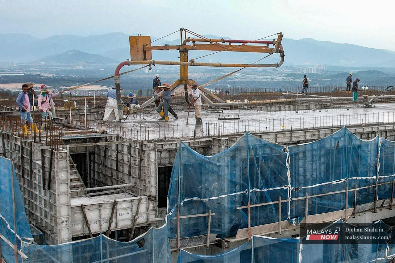 Construction workers carry out their duties at a project site in Selangor. The Malaysian Employers Federation says there is an acute shortage of foreign workers in the country despite the green light given for recruitment.